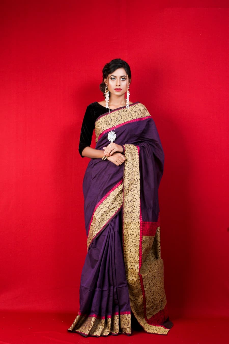 A peshwa-pink Paithani Nauvari saree draped kachha-style with a wide gold zari pallu and parrot-green border